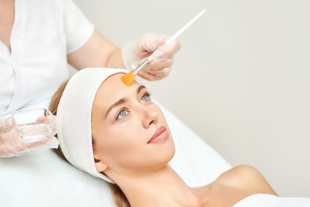 A photo of a modern, professional spa setting with a person receiving a chemical peel treatment.