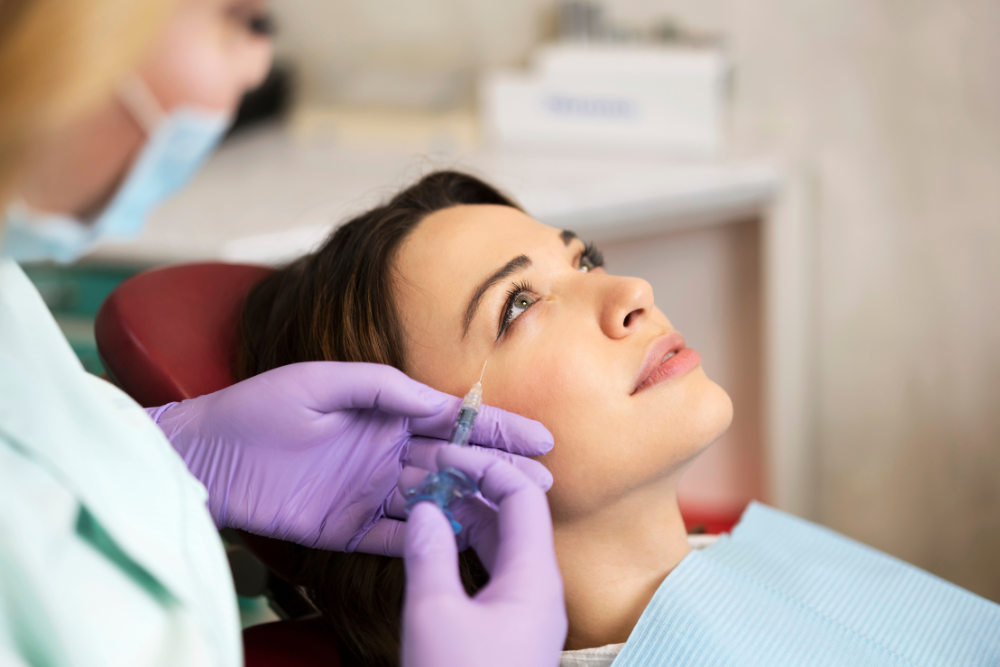 A person applying makeup shortly after a filler treatment, highlighting the minimal downtime associated with the procedure