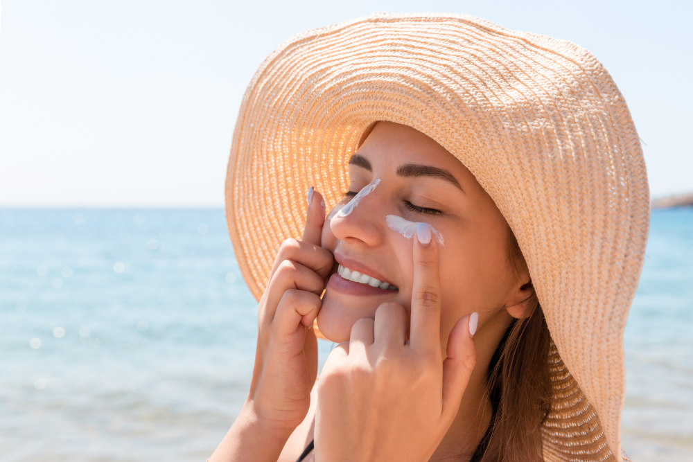 A split-screen image. On one side, a person is applying sunscreen with a sun-protective hat and sunglasses on. The other side shows a person with sunburned skin looking uncomfortable.