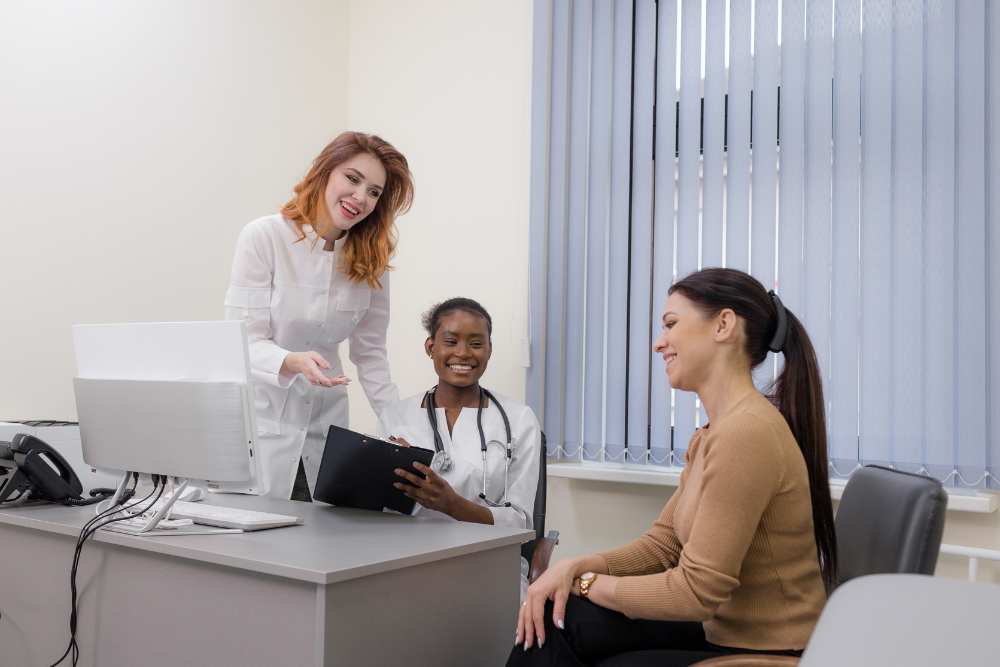 A photo of a person smiling and talking to a healthcare professional during a consultation.